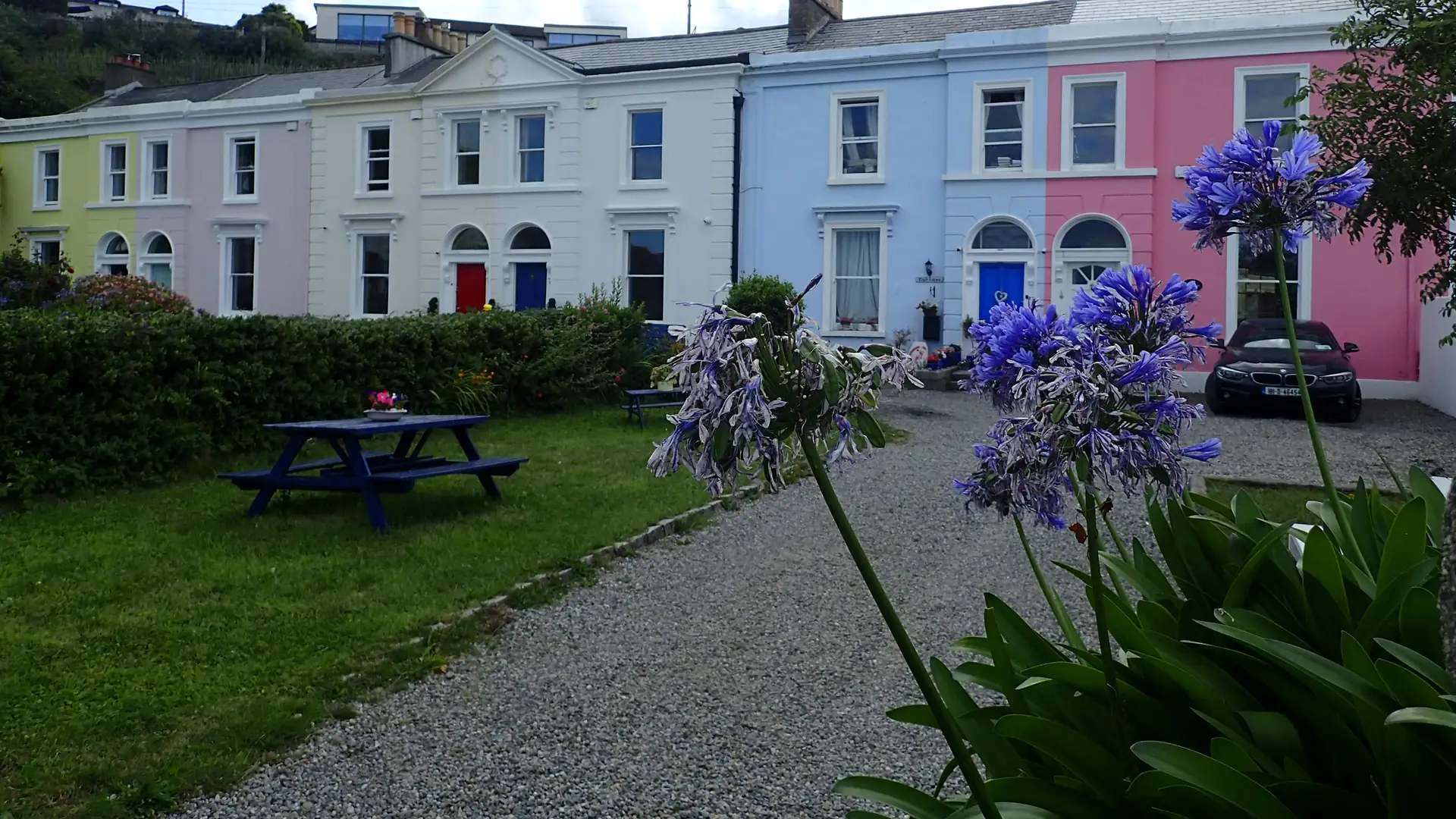 Painted Victorian terrace houses in Bray with a garden in front
