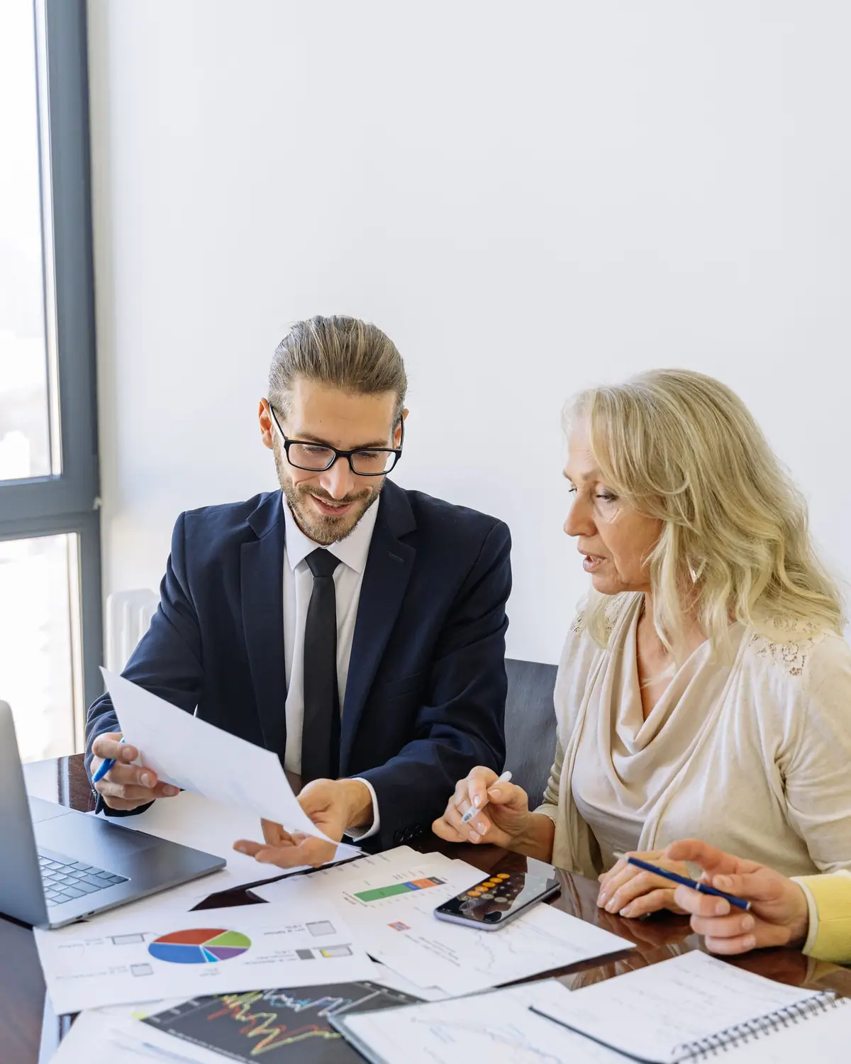 Solicitor and client going through papers at a desk