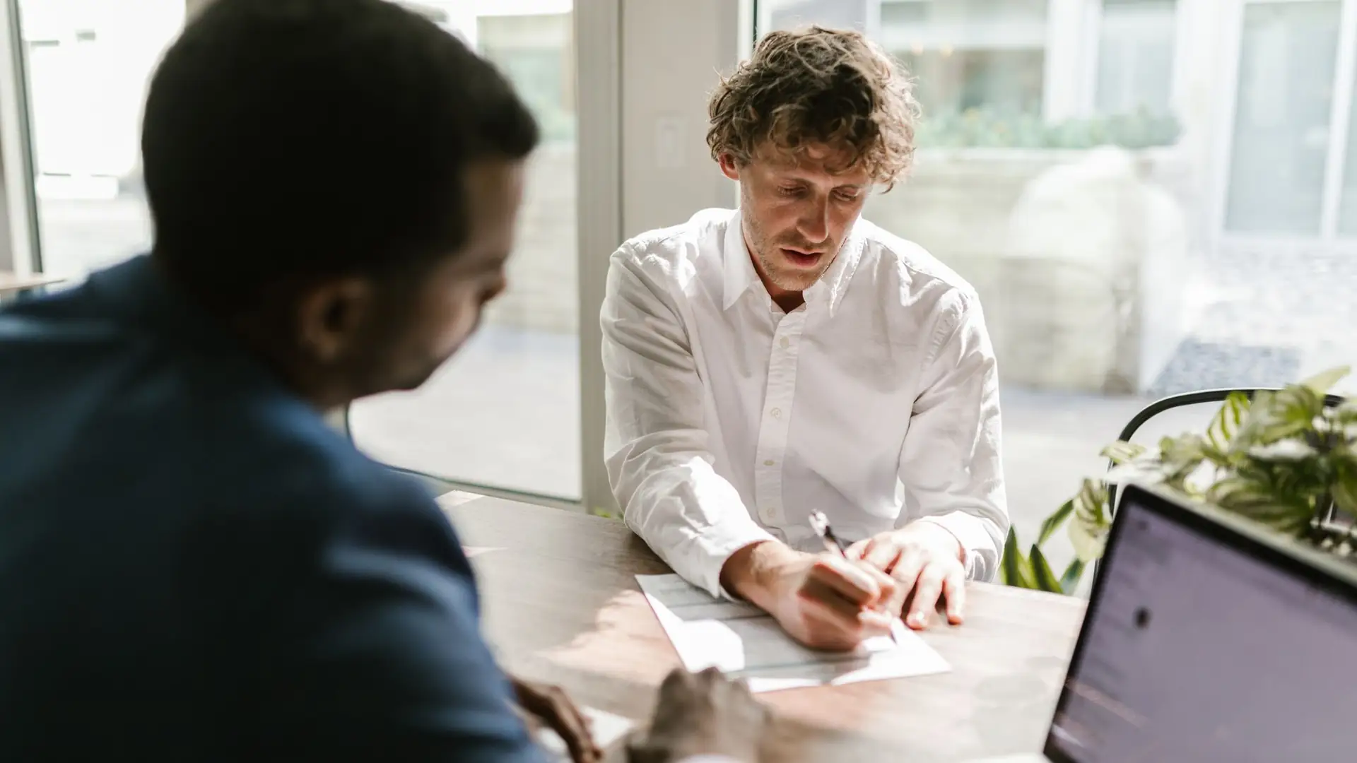 Solicitor and client going through papers at a desk